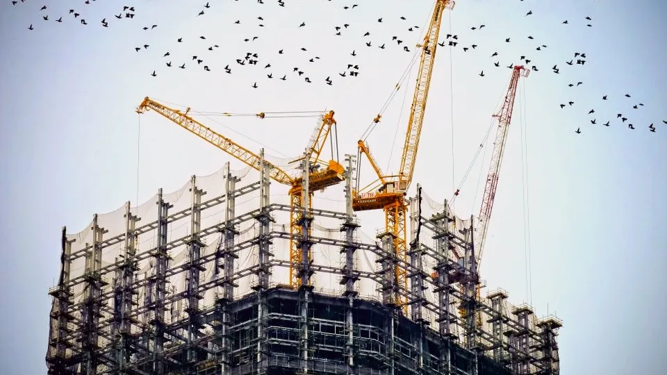 Cranes over a building under construction - real-estate bridge loans are a core Maclear loan type