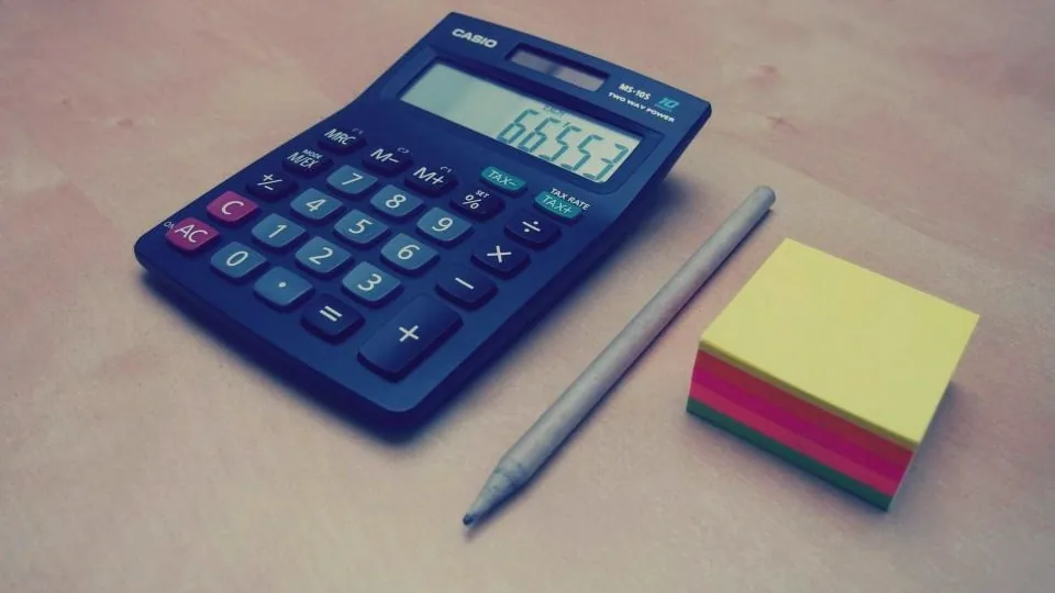 Calculator and notes on a desk - declaring P2P bonuses as taxable income in the EU